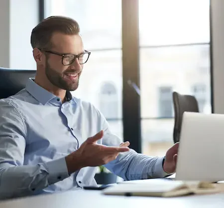 mirthful employee looking laptop screen smiling 386167 2296